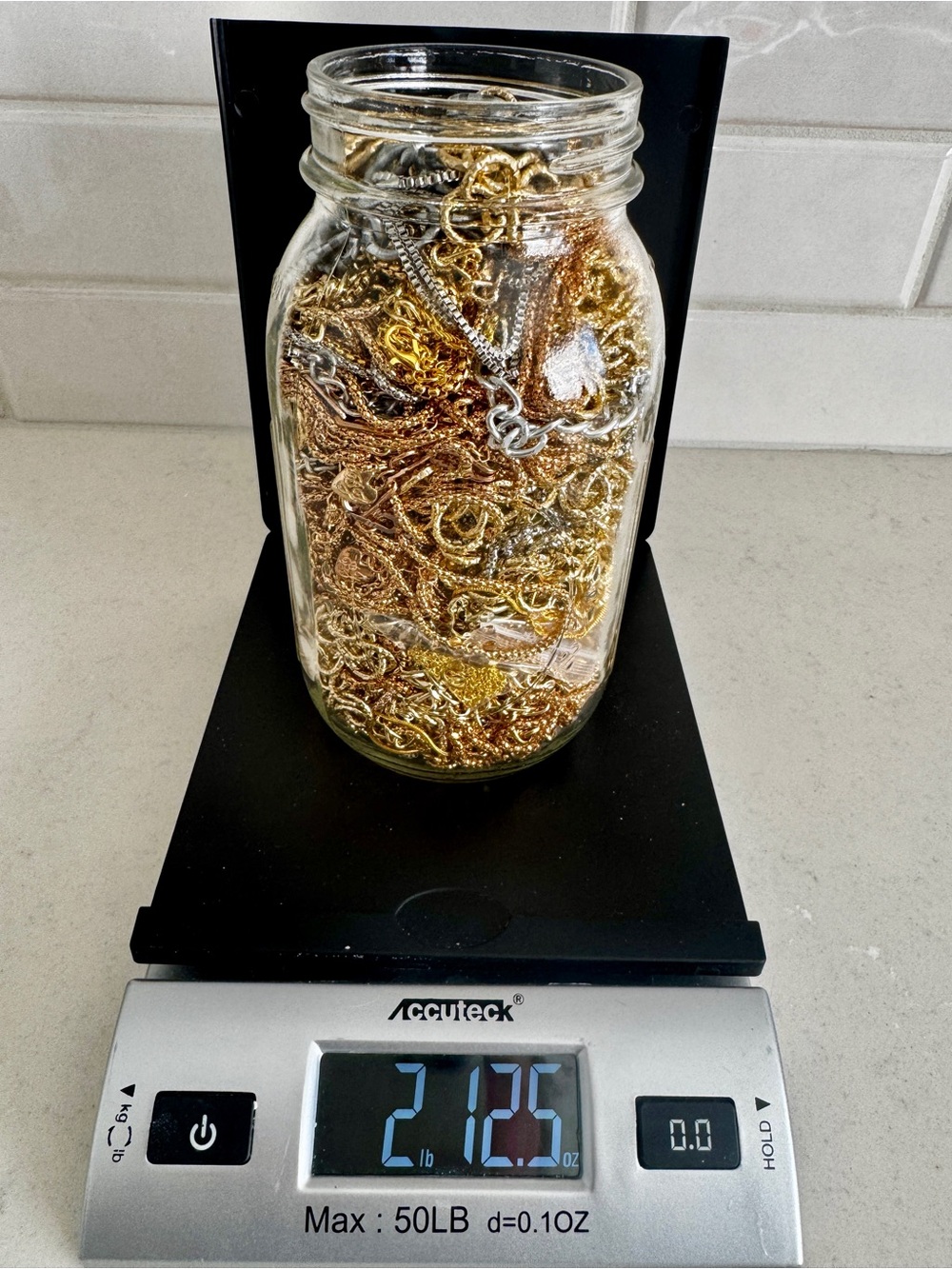 2lbs 12.5oz jar full of necklace chains. Assorted sizes. Silver and gold colors.